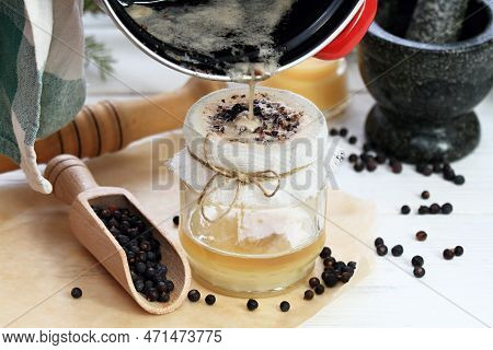 Alternative Medicine, Filtering Juniper  Ointment. Medicinal Cream From Dried Common Juniper Berries