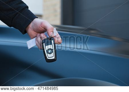 Slovenia, Ljubljana - 31 January 2023: Bmw M4 High Performance Car With Hand Holding Key