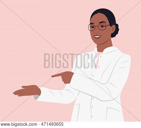 Black Female Doctor In Medical Uniform Pointing And Showing Smth With Hand.