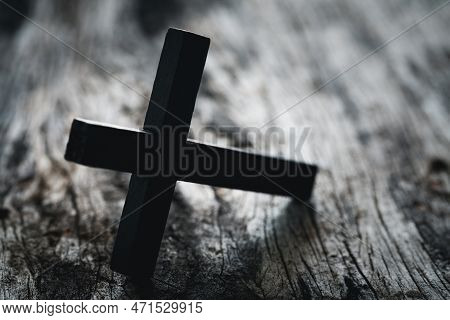A Wooden Christian Cross Crucifix On A Grunge Board Background. Wooden Christian Cross On Grey Table