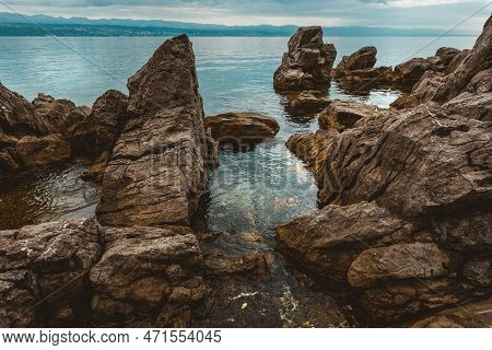 Kvarner Gulf Of Adriatic Sea Rocky Coastline, Large Rocks At Shoreline In Old Town Of Lovran In Croa