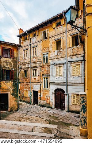 Old Town Of Lovran In Croatia, Distinctive Istrian Architecture With Worn Facades And Wooden Window 