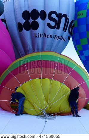 Two Men Preparing A Ballon For Take Off. Taken At 42nd International Balloon Festival In Chateau D'o