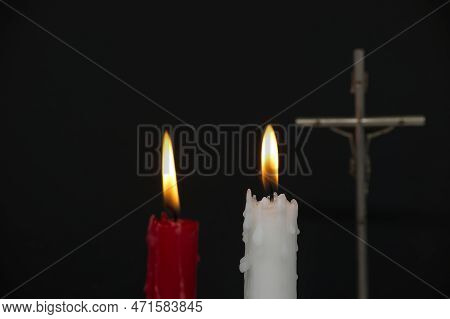 Burning Candles And Christian Cross Against A Black Background With Free Copy Space For Text