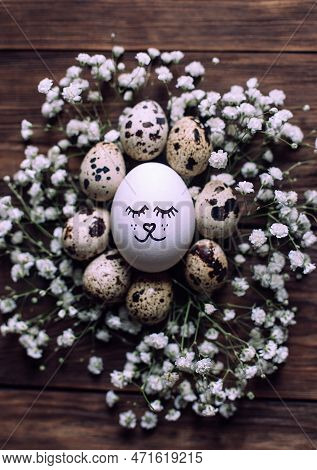 Simple Diy Easter Egg With Drawn Cute Face Surrounded With Quial Eggs In Nest Of Gypsophila Flowers 
