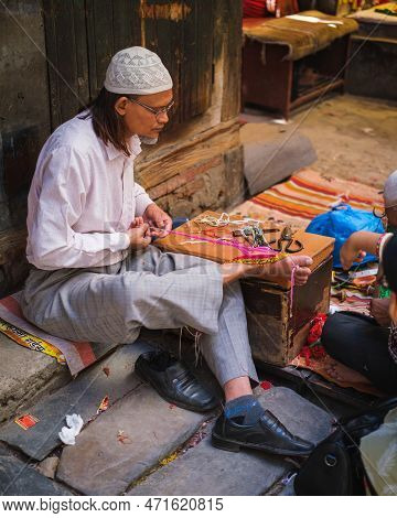 Kathmandu, Nepal, 04 23 2022: Webster Knitting Cloth With His Feet