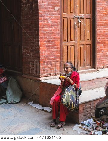 Kathmandu, Nepal, 04 23 2022: A Woman Taking A Break In Kathmandu Bazaar