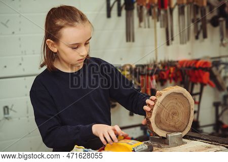 Young Carpenter Working With Wood And Sandpaper In Craft Workshop. School, Development And Learning 