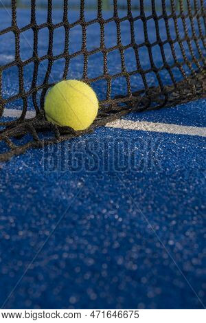 Selective Focus, Paddle Tennis Ball In The Net Of A Blue Paddle Tennis Court. Racket Sports