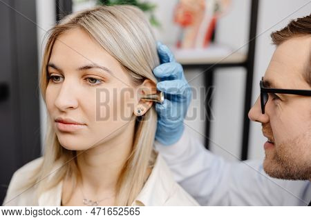 Otolaryngologist Doctor Checking Young Woman's Ear Using Otoscope Or Auriscope At Ent Clinic, Close 