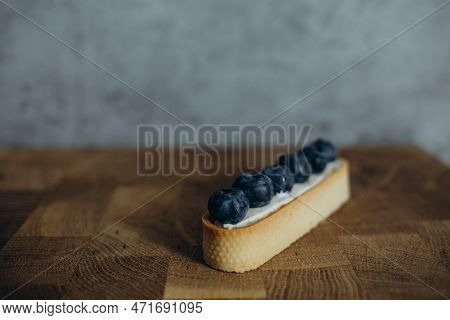 Beautiful Young Chef Decorating Delicious Dessert On Modern Kittchen