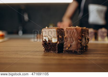 Beautiful Young Chef Decorating Delicious Dessert On Modern Kittchen