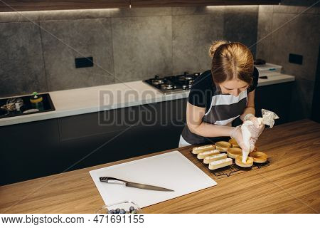 Pastry Chef Decorates The Cake With Berries