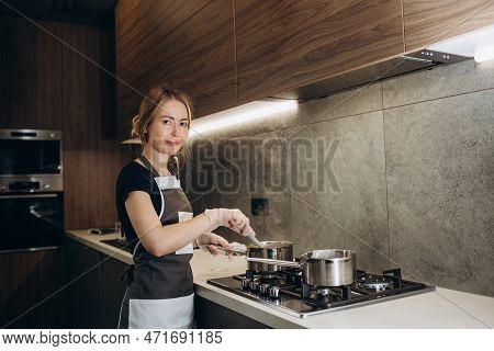 Female Confectioner Prepares Cream In The Kitchen