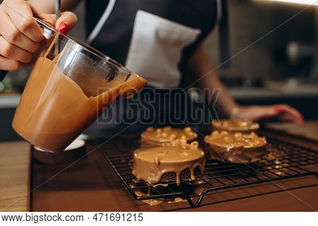 Beautiful Young Chef Decorating Delicious Dessert In Modern Kittchen