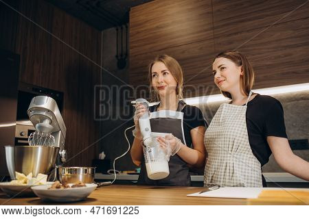 Beautiful Young Chef Decorating Delicious Dessert  In Modern Kittchen