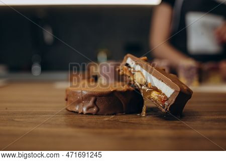 Beautiful Young Chef Decorating Delicious Dessert  In Modern Kittchen