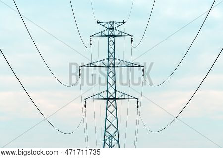 Energy Crisis Concept, Electricity Pylon With Overhead Powerline Cables Against Overcast Sky