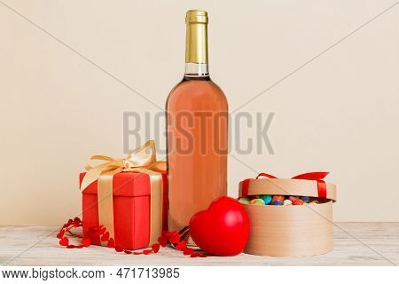 Bottle Of Wine On Colored Background For Valentine Day With Gift Box. Heart Shaped With Presrnt Box 