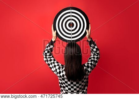 Risk, Psyhology Of Purpose In Business. Concept With Woman Holding Dart Target Above Her Head On A R