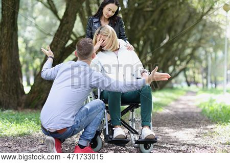 Portrait Of Disabled Unhappy Woman In Wheelchair With Friend. Support And Friendship Concept