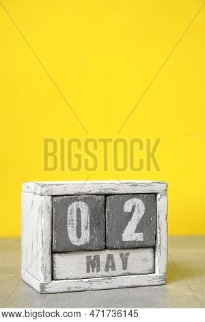 May 2, On Calendar Made Wood Painted In Gray And White, Yellow Background