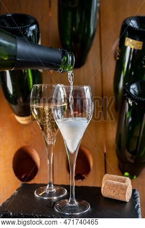 Glasses Of Sparkling White Wine Champagne Or Cava With Bubbles And Classic Wooden Champagne Pupitre