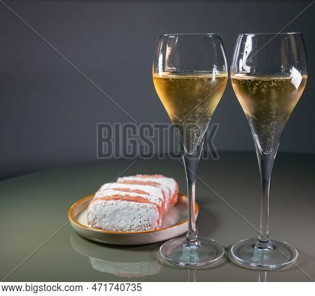 Glasses Of Sparkling White Wine Champagne Or Cava With Bubbles And Sweet Dessert Reims Rose Biscuits