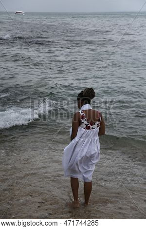 Salvador, Bahia, Brazil - January 1, 2023: Members Of Candombles Make Offerings On The Beach In Umai