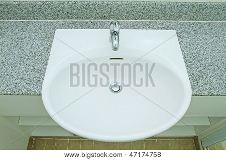 Ceramic Handbasin On Granite Countertop
