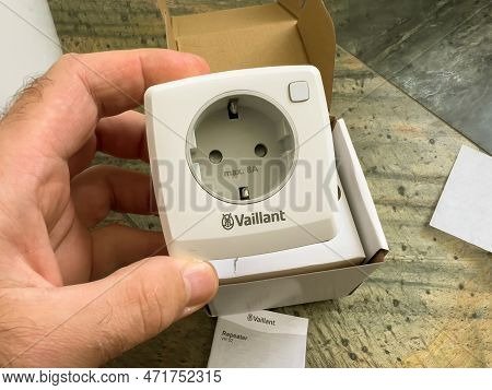 London, United Kingdom - Jan 1, 2022: Pov Close-up Male Hand Holding New Socket Plug Vaillant Ambise