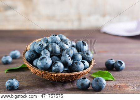 Fresh Blueberries In A Bowl On A Wooden Table. Organic Wild Superfood