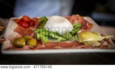 Italian Antipasta Meat Plate With Burrata And Arugula