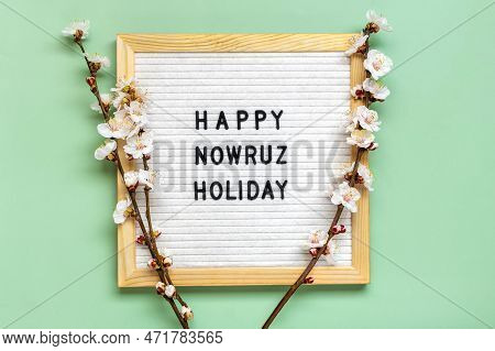 Sprigs Of The Apricot Tree With Flowers On Green Background Text Happy Nowruz Holiday Concept Of Spr