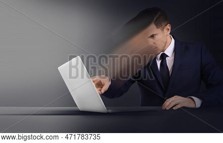Mind Control, Brainwashing Or Work Obsession Concepts. Man Dissolving In Laptop At Table