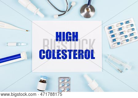 On A Blue Background, A Stethoscope, A Thermometer, Pills, Medicine Bottles And A Piece Of Paper Wit