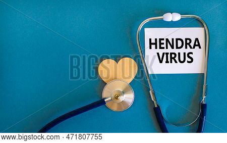 Hendra Virus Symbol. Concept Words Hendra Virus On White Paper Card. Beautiful Blue Table Blue Backg