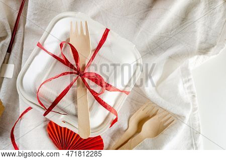 Closed Bento Cake Box With A Wooden Spoon Tied Red Ribbon. Gift Box With Tasty Bento. Cake Packaging
