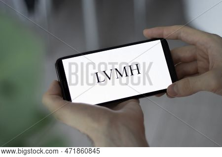 Irpen, Ukraine - January 20 20223, Closeup Of Smartphone Screen Lvmh Logo Lettering With In Mans Han