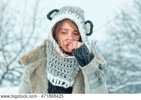 Cold Flu Winter Season, Runny Nose. Showing Sick Woman Sneezing At Winter Park.