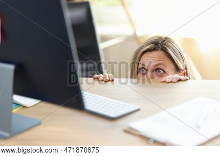 Portrait Of Surprised And Excited Female Peeping Out Desk And Looking At Pc Screen. Office Worker Hi