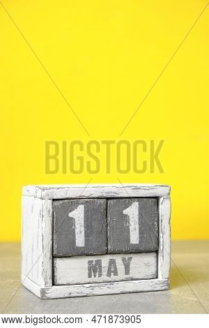 May 11, On Calendar Made Wood Painted In Gray And White, Yellow Background