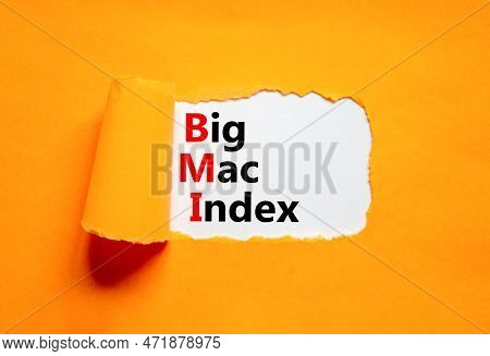 Bmi Big Mac Index Symbol. Concept Words Bmi Big Mac Index On White Paper On A Beautiful Orange Backg