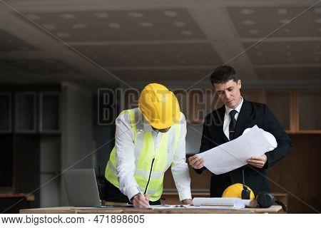 Diverse Team Of Specialists Use Laptop On Construction Site. Real Estate Building Project With Engin