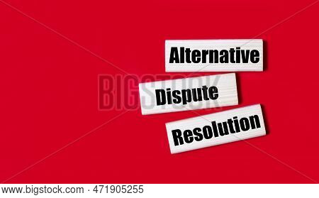 Three Wooden Blocks With The Text Adr Alternative Dispute Resolution On A Bright Red Background. Cop