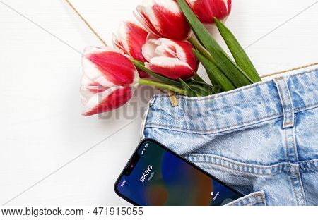 Tulips On Jeans And Spring Calling On Smartphone Kid Holding Flower