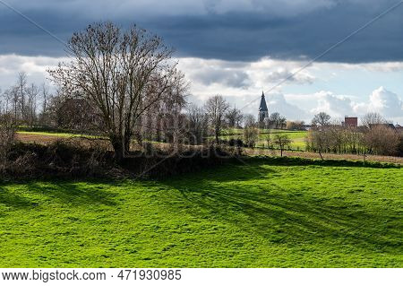 View Over The Green Fields And Meadows With The Village Of Ossel In The Background, Merchtem, Belgiu