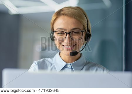 Young Female Office Worker Close Up, Businesswoman With Headset Phone For Video Call Talking To Clie
