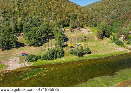 Southern Urals, Tourist Camp By The Mountain River Zilim Near The Kinderlin Cave. Aerial View.