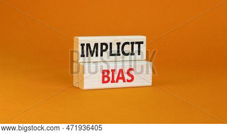 Implicit Bias Symbol. Concept Words Implicit Bias On Wooden Block. Beautiful Orange Table Orange Bac
